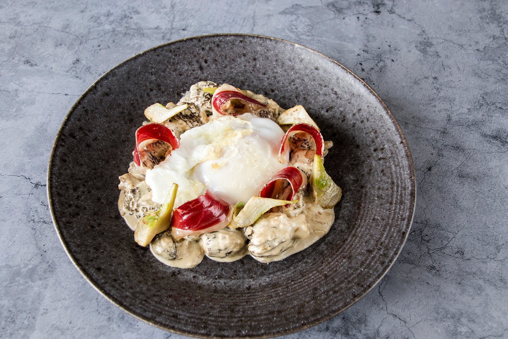Fried goose egg with morels