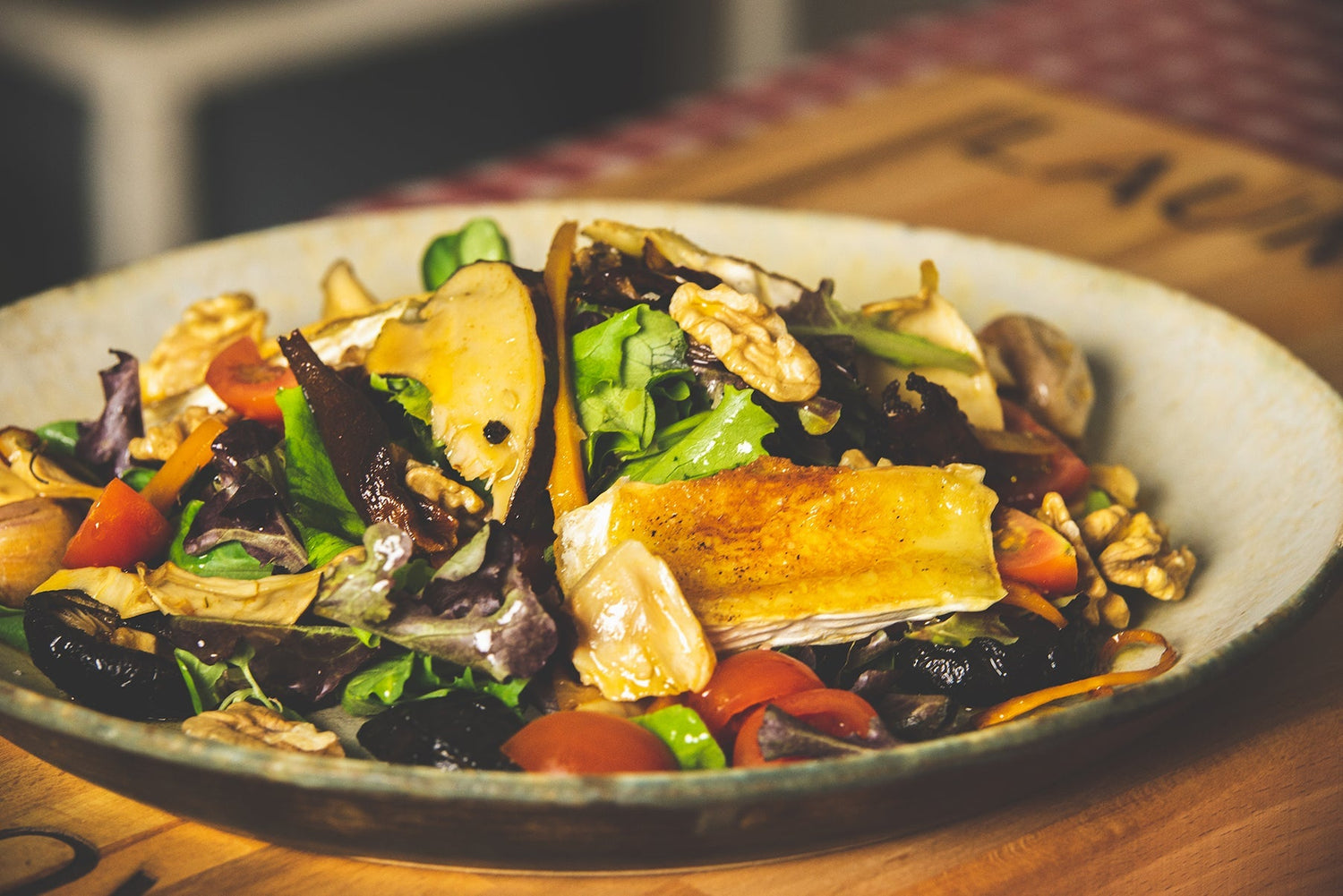 Salad of marinated mixed mushrooms, Brie cheese, cherry tomatoes, and walnuts