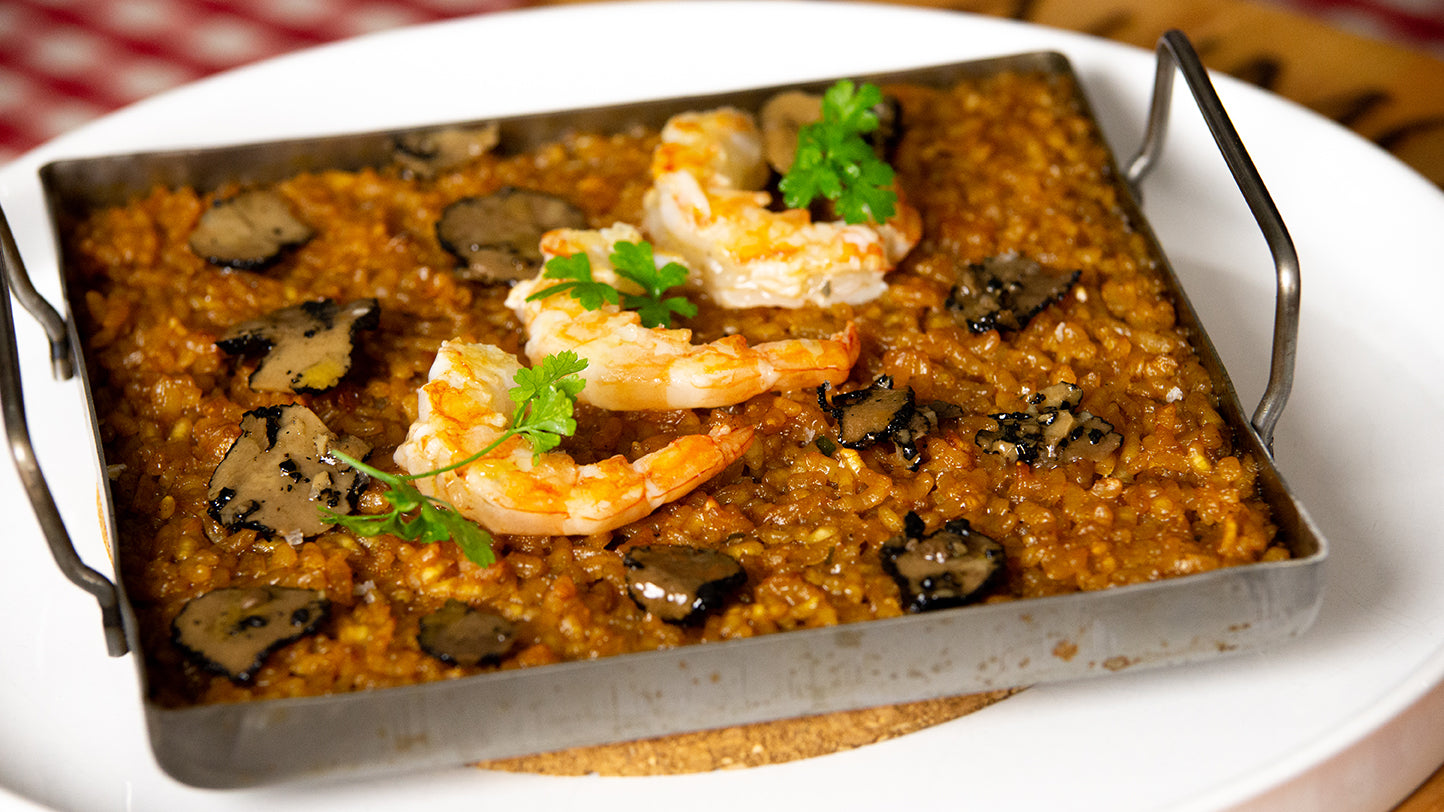 Rice served with summer truffle carpaccio, prawns and vegetables